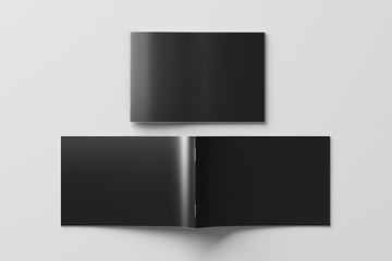 Black horizontal brochure or booklet cover mock up on white. Closed one brochure and upside down other. Clipping path around brochure. View above. 3d illustratuion