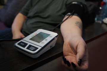 Measurement of blood pressure using a tonometer. A blood pressure monitor measures the pressure on...