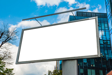 Advertising billboard mockup in front of modern office buildings - obrazy, fototapety, plakaty