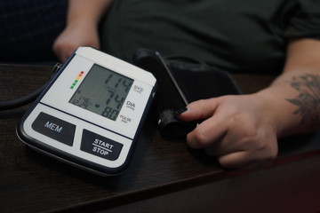Measurement of blood pressure using a tonometer. A blood pressure monitor measures the pressure on a woman.
