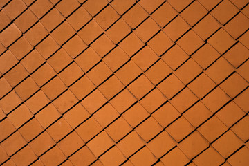 Natural orange roof tiles on a building as a texture.