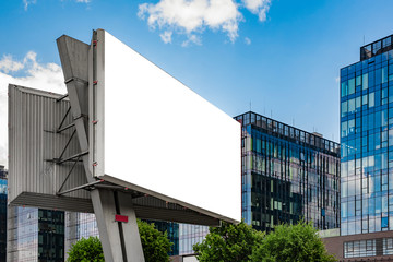 Advertising billboard mockup in front of modern office buildings