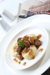 Silesian dumplings on white plate