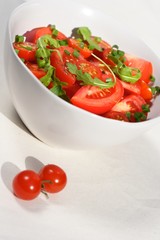 Close  - up of sliced tomatoes with rucola
