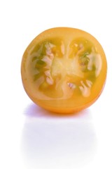 Halved yellow tomato on white background
