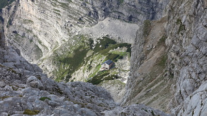 New Alpine hut on green grass surrounded by rocks, Alps, Austria.