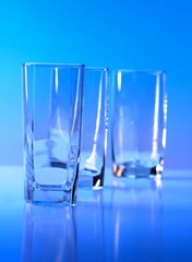 Empty glass on blue background
