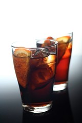 Close-up of cola with ice and lemon