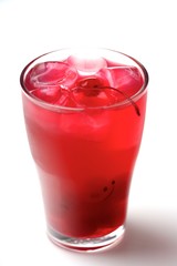 Drink with ice cubes and cherries on white background