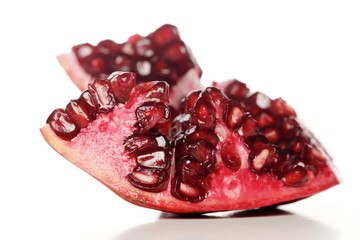 Close-up of pomegranate seeds on white background