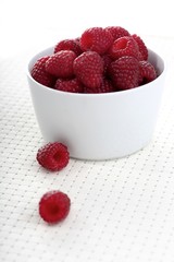 Raspberries in white bowl - close-up