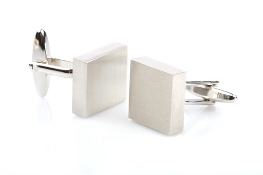 Silver cuff links on white background