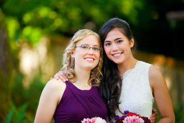Beautiful biracial young bride smiling with her multiethnic group of bridesmaids