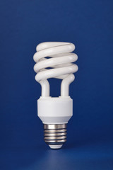 Energy saving lightbulb isolated on color background. Close up.