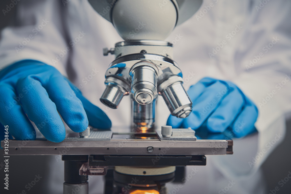 Wall mural close-up shot of microscope with metal lens.