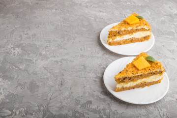 Homemade cake with persimmon and pumpkin on a gray concrete background. side view, copy space.