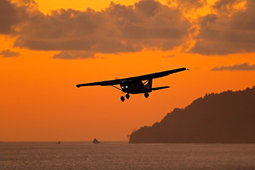 Ait travelling in Costa Rica. Evening sunset in sea coast of Corcovado NP, Costa Rica. Aircraft on...