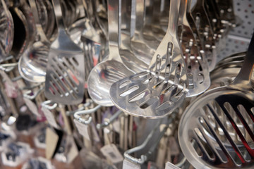 Chrome colored spoons and other different kinds of kitchenware