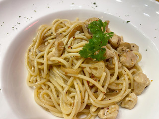 Chicken olio spaghetti with parsley garnish