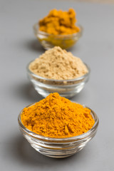 Herbal therapy concept. Spice set: ginger and turmeric powder, turmeric paste on light background. .
