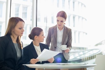 Businesswomen with paperwork during coffee break