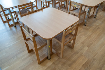 Kyiv, Ukraine - October 14, 2019: Interior of a spacious kindergarten room with small children tables and chairs.