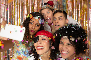 Group of costumed friends make a frowning photo at the party. Costumed Pirate and Hippie Women....