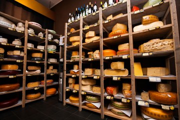 Cheese arranged in shelves at store