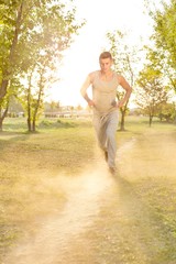 Full length of man listening music while running in park