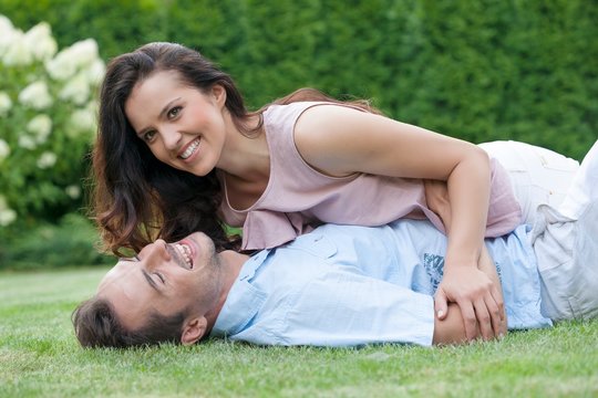Playful young couple having leisure time in park