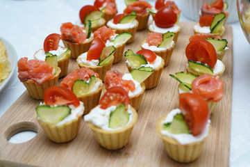 Bright tartlets with red fish and cucumbers.