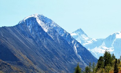 Fototapeta premium snowy mountain peaks against the sky and a mountain plateau from a height