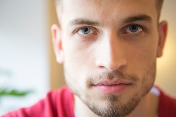 Close-up portrait of confident man in cafe