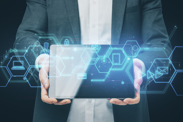 Businessman holding tablet with digital business interface