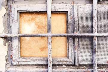 Background rust texture. Hard old painted grey wall with wooden window and lattice in grunge style. Surface for design and text. Close up view