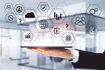 Hand holding tablet with global business interface