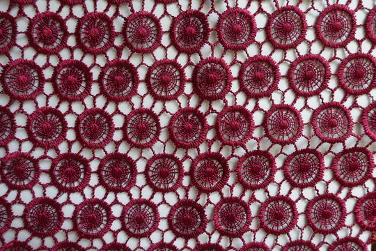 Top view of dark red lacy fabric