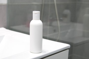 White bottle with cosmetic in the bathroom