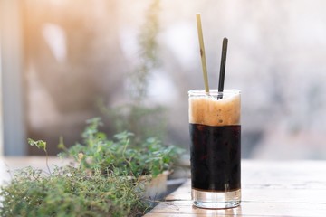 A glass of ice americano in coffee cafe