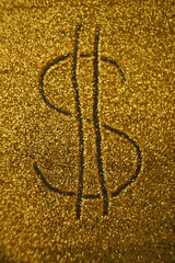 Dollar sign on golden shiny background.