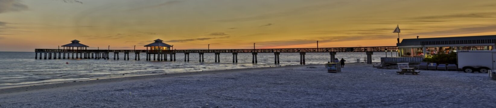 Panoramic picture of Fort Myers fishing pier at sunrise with afterglow