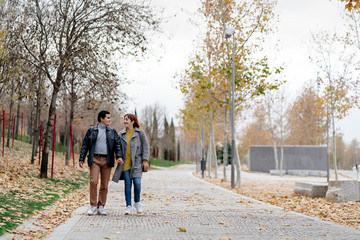 Unrecognizable happy couple walking together in the city