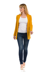 Young Woman In Yellow Unbuttoned Jacket And High Heels Is Walking Towards Camera - 312527034