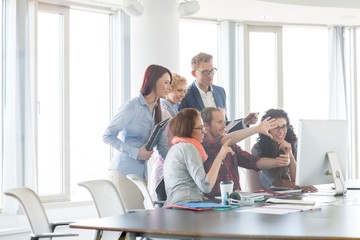 Business people using computer in office