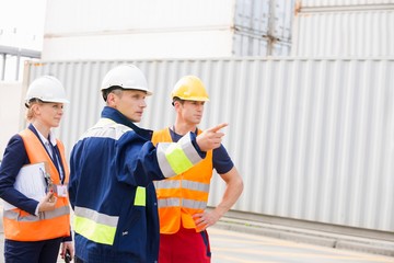 Workers discussing in shipping yard