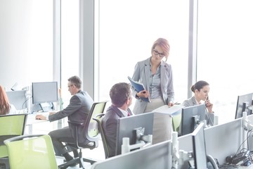 Business people working in open plan office