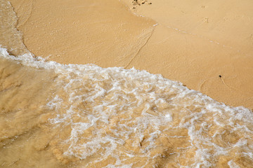 Water waves crushing on a sandy beach - sand summer sun swim swimming wave yellow wet crush rolling splash splashing holiday vacation