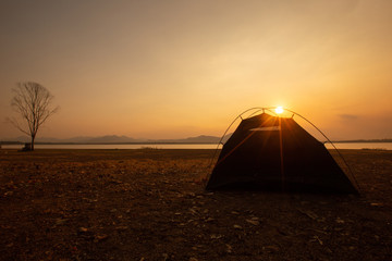 Tent camping at sunset on holiday.
