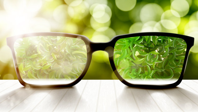 Modern Eyeglasses On Wooden Table And Bokeh Back