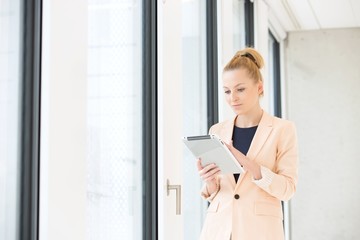 Young businesswoman using tablet computer in office
